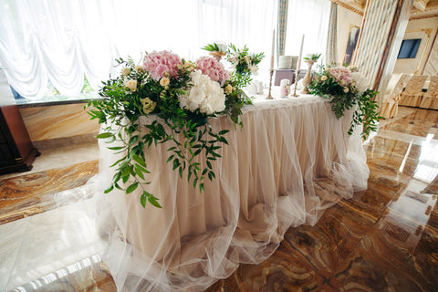 One of the most popular trends in wedding at the moment is having a sweetheart table.Some couples are choosing to have ornate, luxurious sweetheart tables with lush floral garlands that spill onto the floor, candles and sequined table linens, while others are choosing to have plush, vintage chairs seated around a rustic wooden table with a scatter of lanterns for a more simple, yet still elegant. Includes: Flower arrangements: white and pink hydrangea, white lisianthus, creamy mini roses,assorted greens. Ca