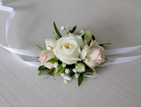  fresh, feminine mix of pink, white and green.    Light pink spray roses with babie`s breath