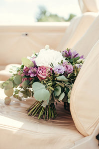 Bridal and prom bouquet with white hydrangea,  purple roses and lisianthus.