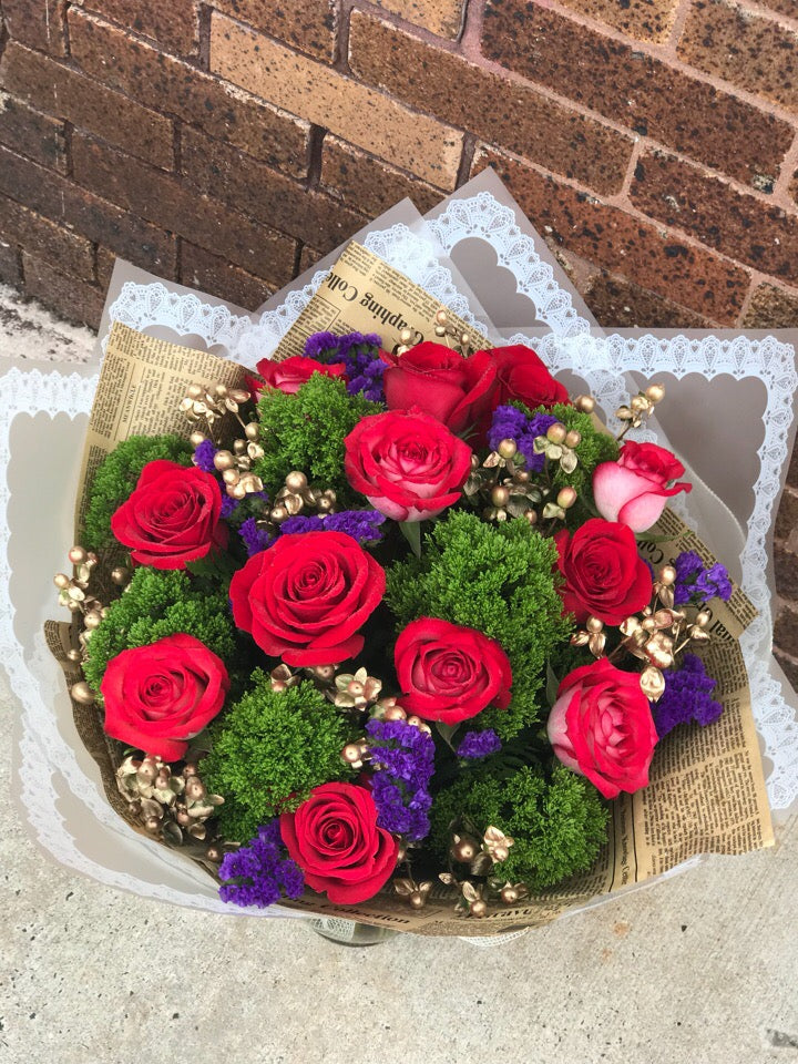 Bold and beautiful! This gorgeous arrangement is a stunning statement of devotion!  Includes:  Red roses, stacice, gold berries, assorted greens. Free message card