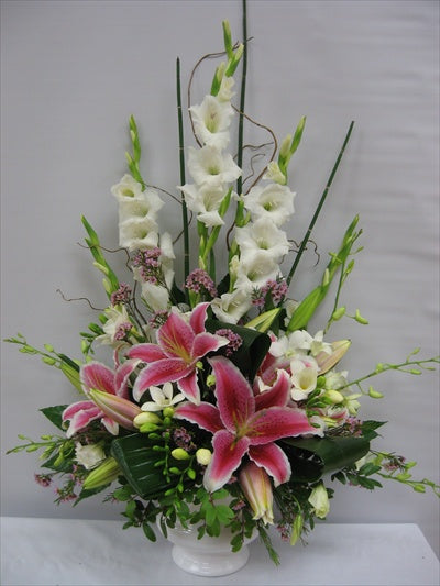 Funeral arrangement with pink lilies, orchids and gladiolus