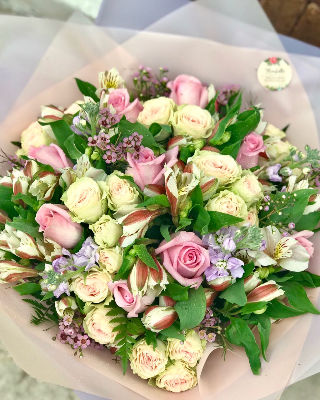 It's beauty-full!  This delightful pink arrangement brings spring joy to that special someone.  Includes:  Pink roses, creamy mini roses, white alstroemerias, lavender stock, pink wax flowers, fern. Wrapped in a craft paper Free message card