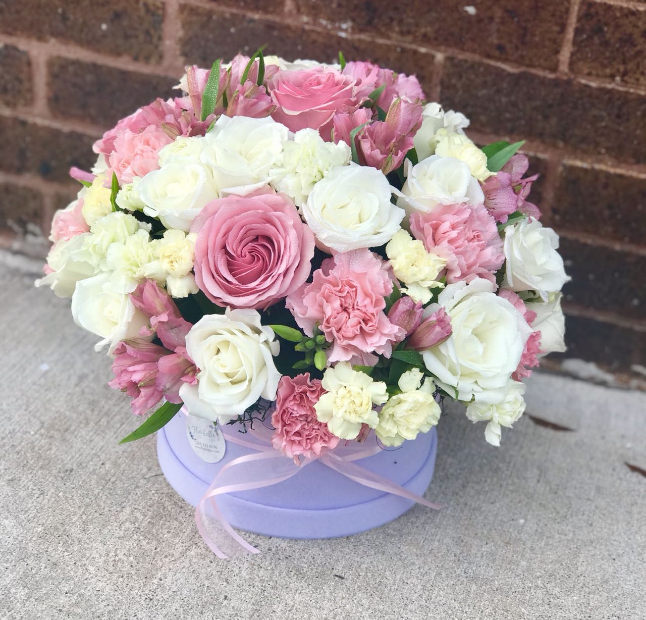 A stunning orchid flower box with vibrant flowers. The perfect gift for birthday, baby shower, wedding.  Includes:  Pink roses,white roses, pink alstroemerias, light yellow and green carnations. Velvet box Free message card