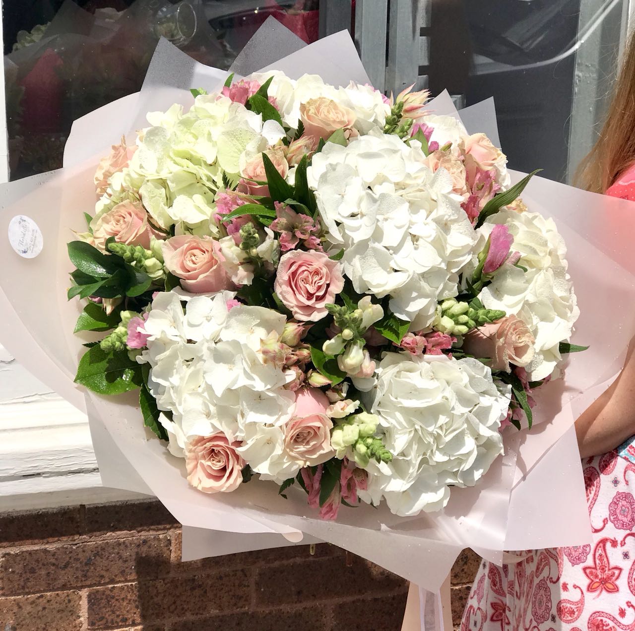 Stunning in its simplicity, this innocent harmony of light pink roses and snow white hydrangeas are a heartfelt way to send your very best.  Includes:  White hydrangea, light pink roses, pink alstoemerias, assorted greens. Wrapping in a craft paper. Free message card
