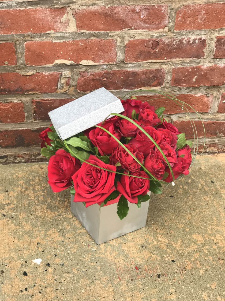 Remember the glorious feeling when you both starting falling in love? Fan the flame with this wildly romantic bouquet.   Includes:  Red roses, assorted greens. Box Free message card