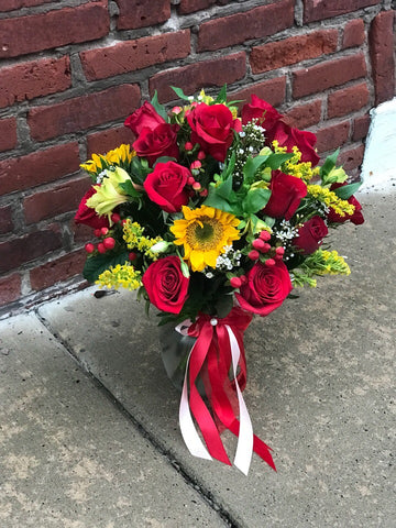 Happy yellow sunflowers and red roses bring sunshine to your Thanksgiving!  Includes:  Red roses, sunflowers, solidago, red berries,assorted greens. Vase Free message card