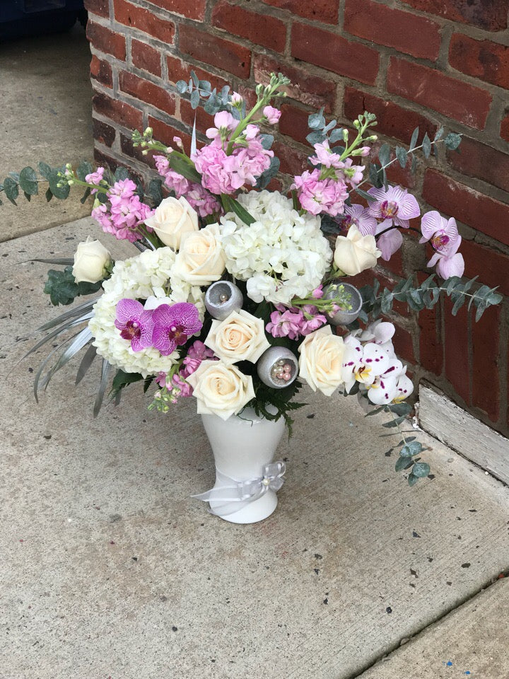 She'll always be your #1 lady. Remind her just how special she is - send a sensational gift she'll never forget. This beautiful bouquet  is sure to make an impression!  Includes:  White hydrangea, pink stock, white roses, pink orchids, eucalyptus. Vase Free message card