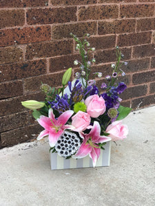 Send her on a dreamy stroll through a garden with this perfect-for-any-occasion bouquet.   Includes:  Pink lilies and roses, blue delphinium Floral envelope Free message card Dried lotus  