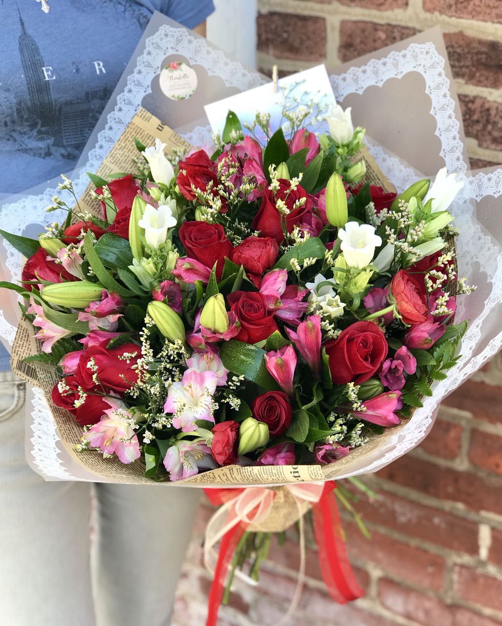 Whether for your significant other or your sister, aunt or grandmother, this delightful floral gift is a sweet way to say "I love you."  Includes:  Red roses, bells, pink alstroemeria, white lilies, limonium, assorted greens. Wrapped in craft paper. Free message card